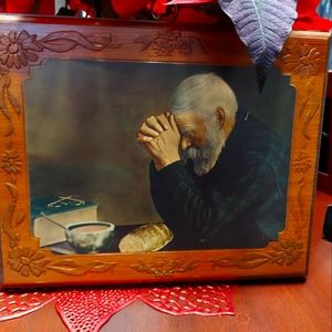 Wooden picture of old man praying